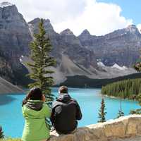 Couple looking at a Aquamarine Lake landscape in Banff National Park, Alberta, Canada