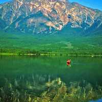 Canoeing in a emerald green lake in the Canadian Rockies