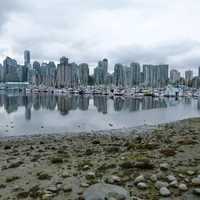 Skyline of Vancouver across the water with boats in British Columbia, Canada