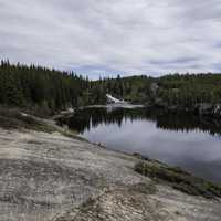 Landscape of the Cameron River with the waterfall in the distance on the Ingraham Trail