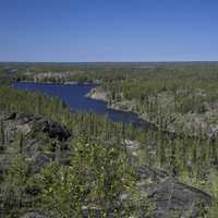 Long Blue lake in the middle of Pine Forest on the Ingraham Trail