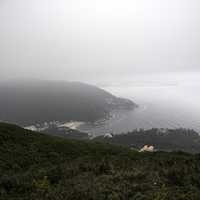 Mountainside foggy landscape with sea