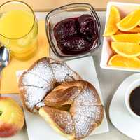 Hotel breakfast tray with oranges, coffee, and juice, and croissants
