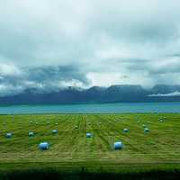 Bales of Hay under the clouds under the sky landscape