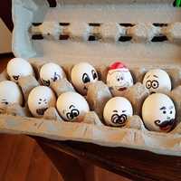 Eggs with faces on them in a box