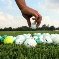 Hands placing golf balls