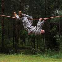 AFENWOEHR, Germany - Spc. Leroy Suquitana, a USARUER HHBN Soldier working as a reception cell clerk, negotiates the rope-bridge obstacle 20 Aug. during the 2013 Best Warrior Competition’s obstacle course here. The U.S. Army Europe Best Warrior Competition is a weeklong event that tests Soldiers’ physical stamina, leadership and technical knowledge and skill.  Winners in the Soldier and Noncommissioned Officer categories of the USAREUR competition will go on to compete at the Department of the Army level. (U.S. Army photo by Spc. Joshua Leonard)