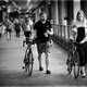 black-and-white-of-two-people-walking-their-bikes