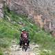 people-riding-a-donkey-on-a-mountain-path