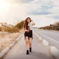 pretty-woman-walking-on-the-side-of-the-road