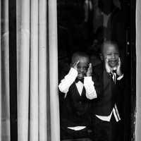 two-african-american-kids-looking-through-window
