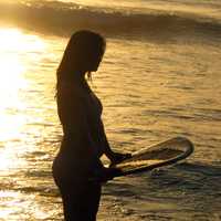 woman-on-beach-with-surf-board