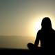 women-meditating-at-sunset