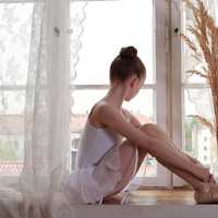 young-ballerina-dancer-sitting-at-the-window