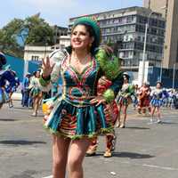 Woman in festival costume dancing in Lima, Peru