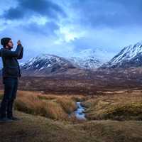 Man taking photo of the Majestic Mountains