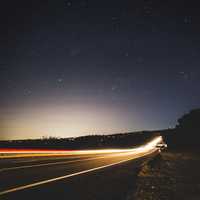 Lighted highway under the stars at Forest Hill Bridge, California