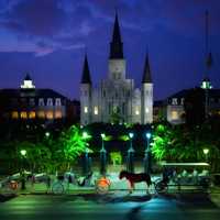 New Orleans evening city with horse carriages in Louisiana