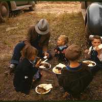 Homesteader and his children eating barbeque at the New Mexico Fair