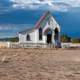 Women riding horse near a small church in Santa Fe, New Mexico