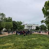 Distant View of the White House with People standing in Front of it