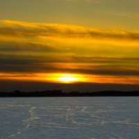 Large sunset over snowy Mendota in Madison, Wisconsin