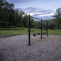 Swingset and landscape under the sky at Stewart Lake County Park