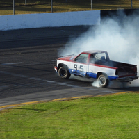 Smoke from tires from truck rallying around track