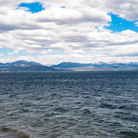 Across the waters  of Yellowstone Lake and mountains