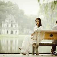 Couple sitting on a bench at Ho Guom at Hanoi, Vietnam