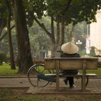 Person sitting on a bench on Hanoi, Vietnam