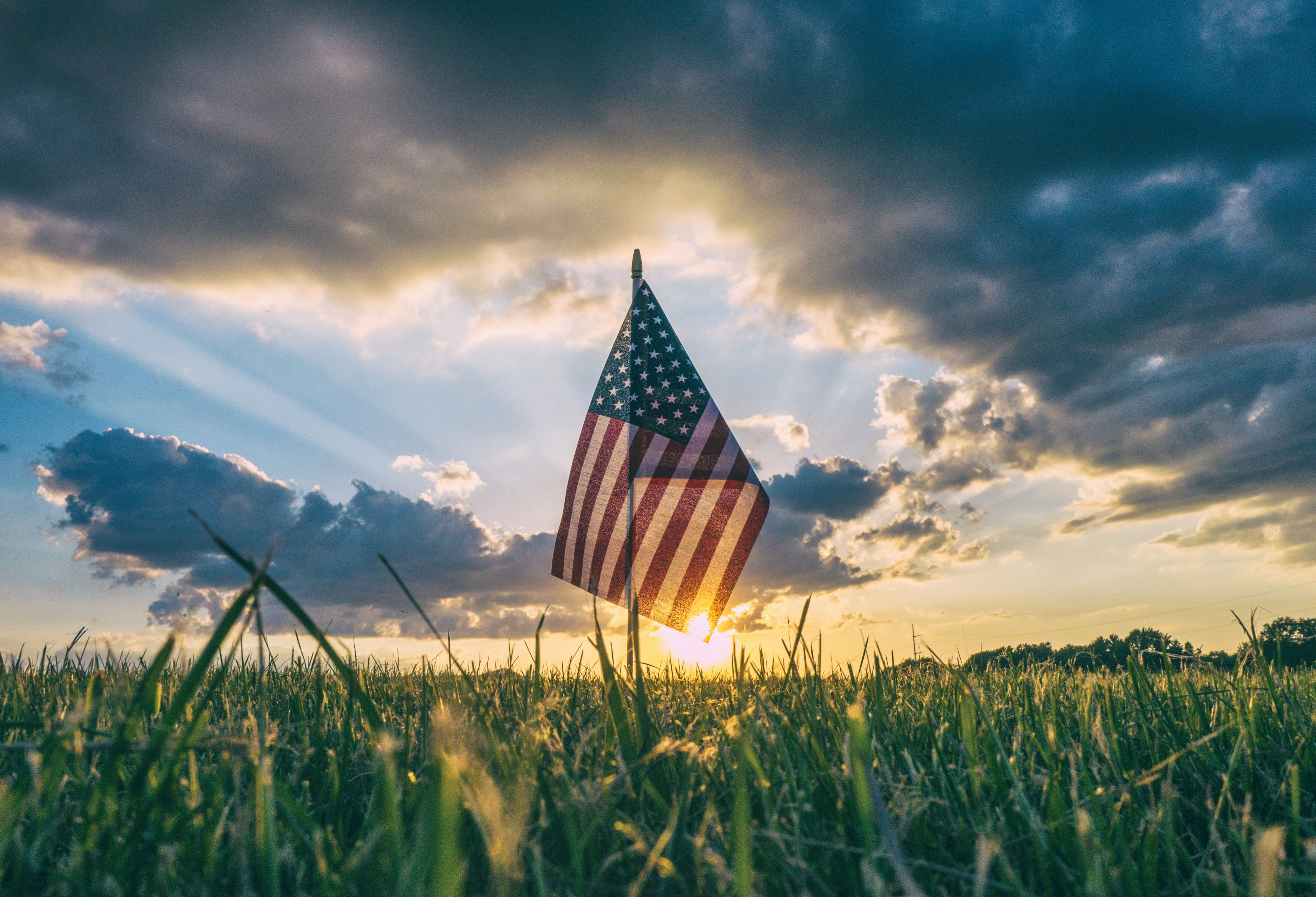 Sunset Beyond The American Flag Celebrating 4th Of July