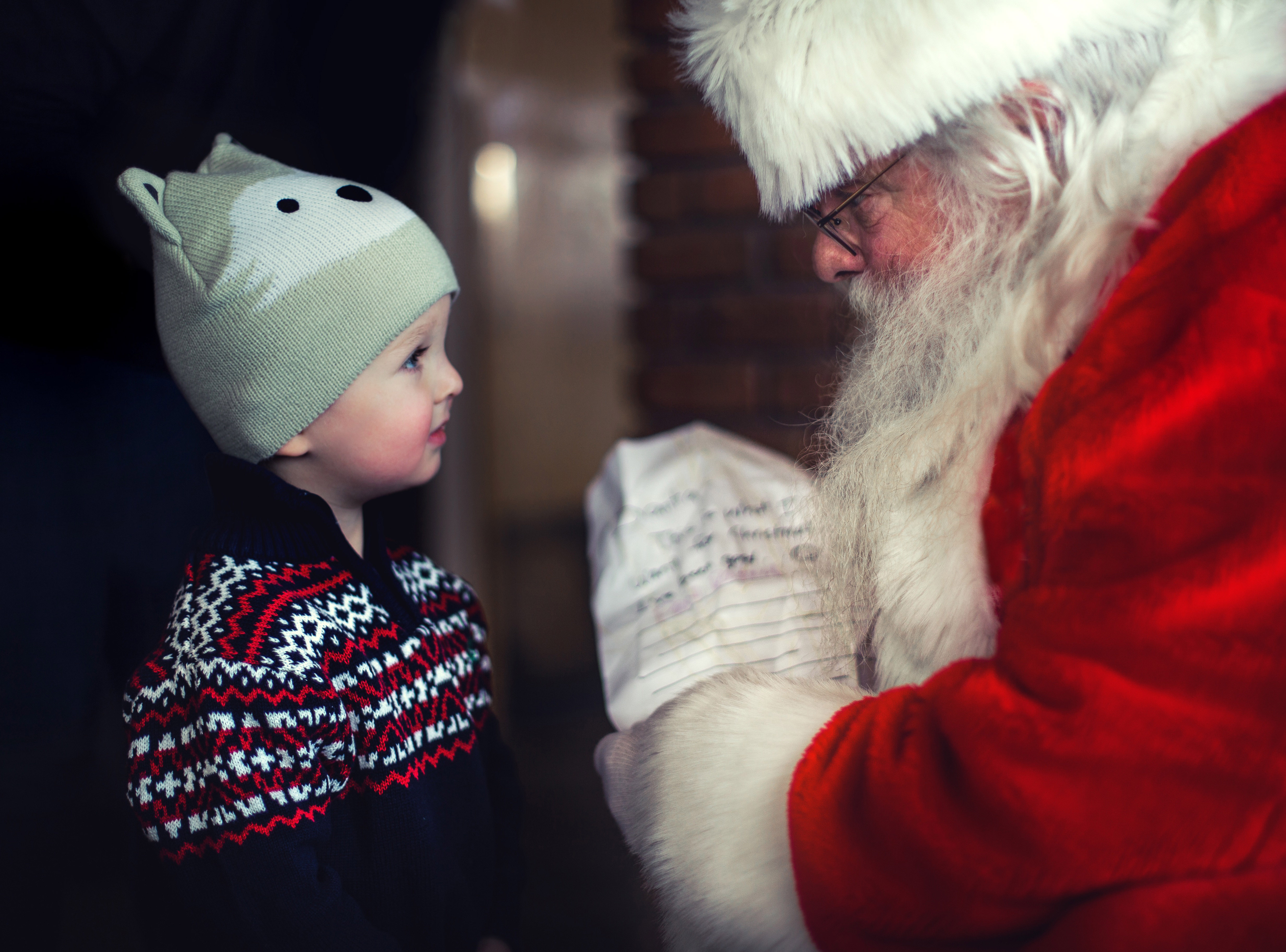 Santa talking with a young child image Free stock photo
