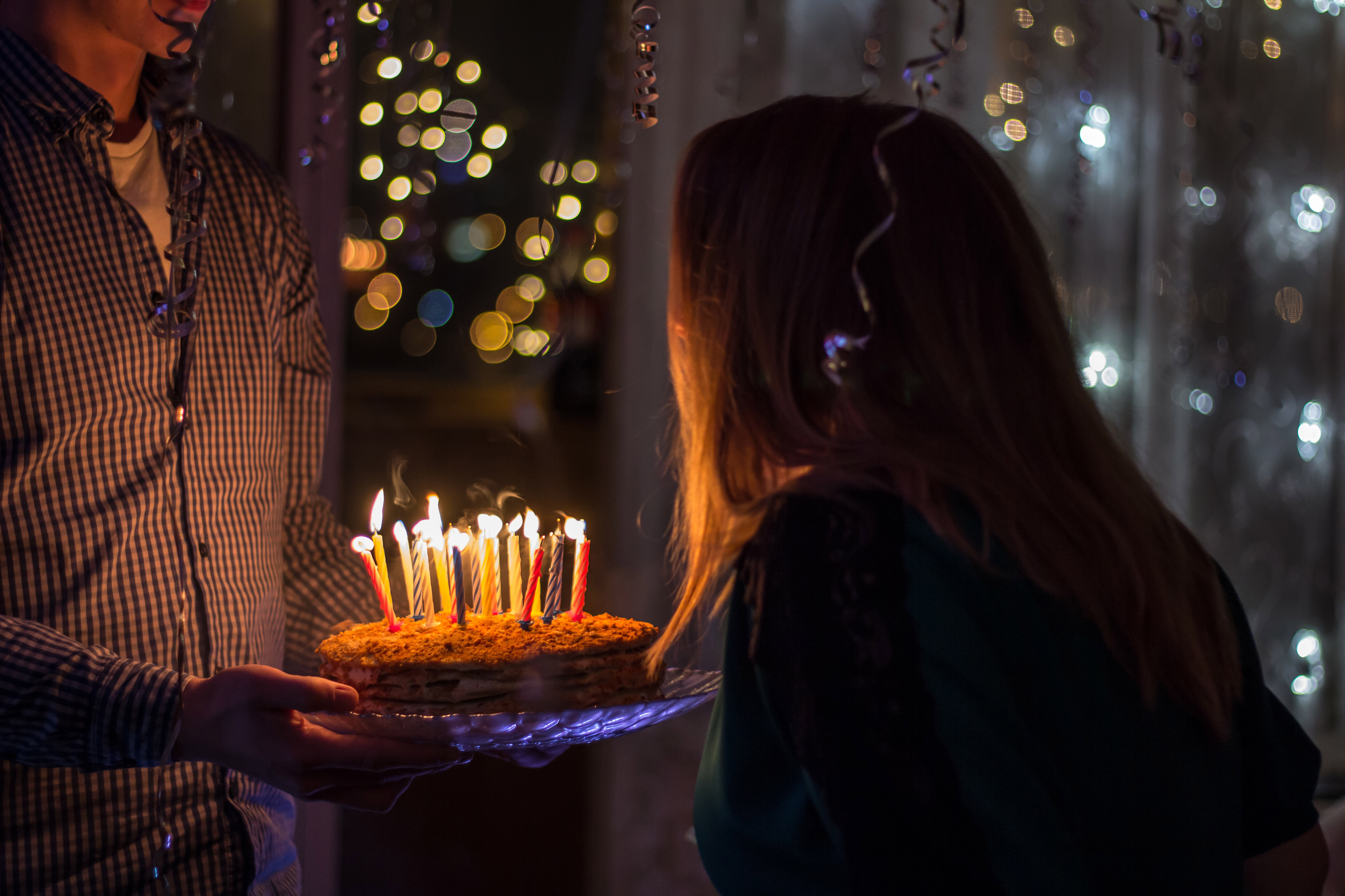 Close up head shot of sad boy about to blow up his candles in birthday cake.  Generative AI Stock Illustration | Adobe Stock