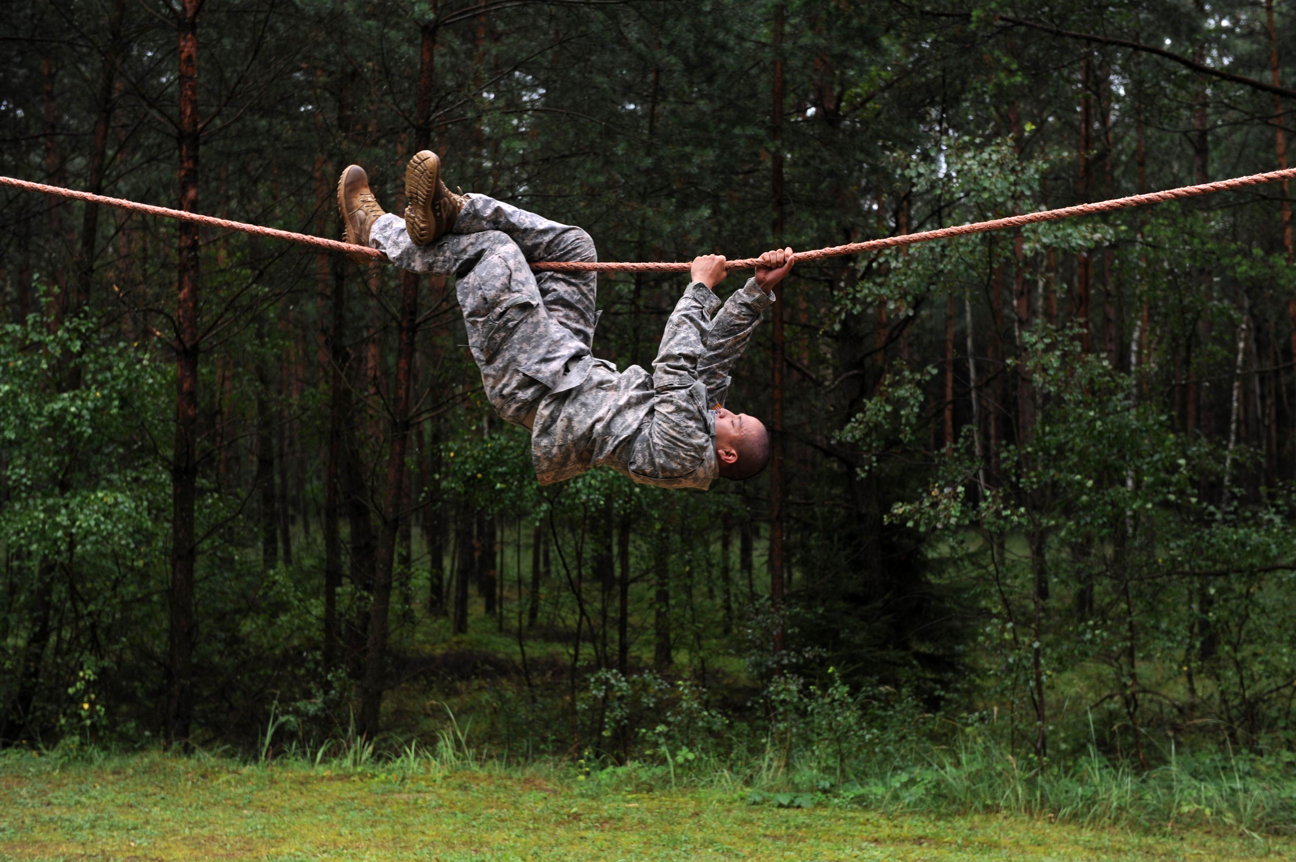AFENWOEHR, Germany - Spc. Leroy Suquitana, a USARUER HHBN Soldier working  as a reception cell clerk, negotiates the rope-bridge obstacle 20 Aug.  during the 2013 Best Warrior Competition's obstacle course here. The