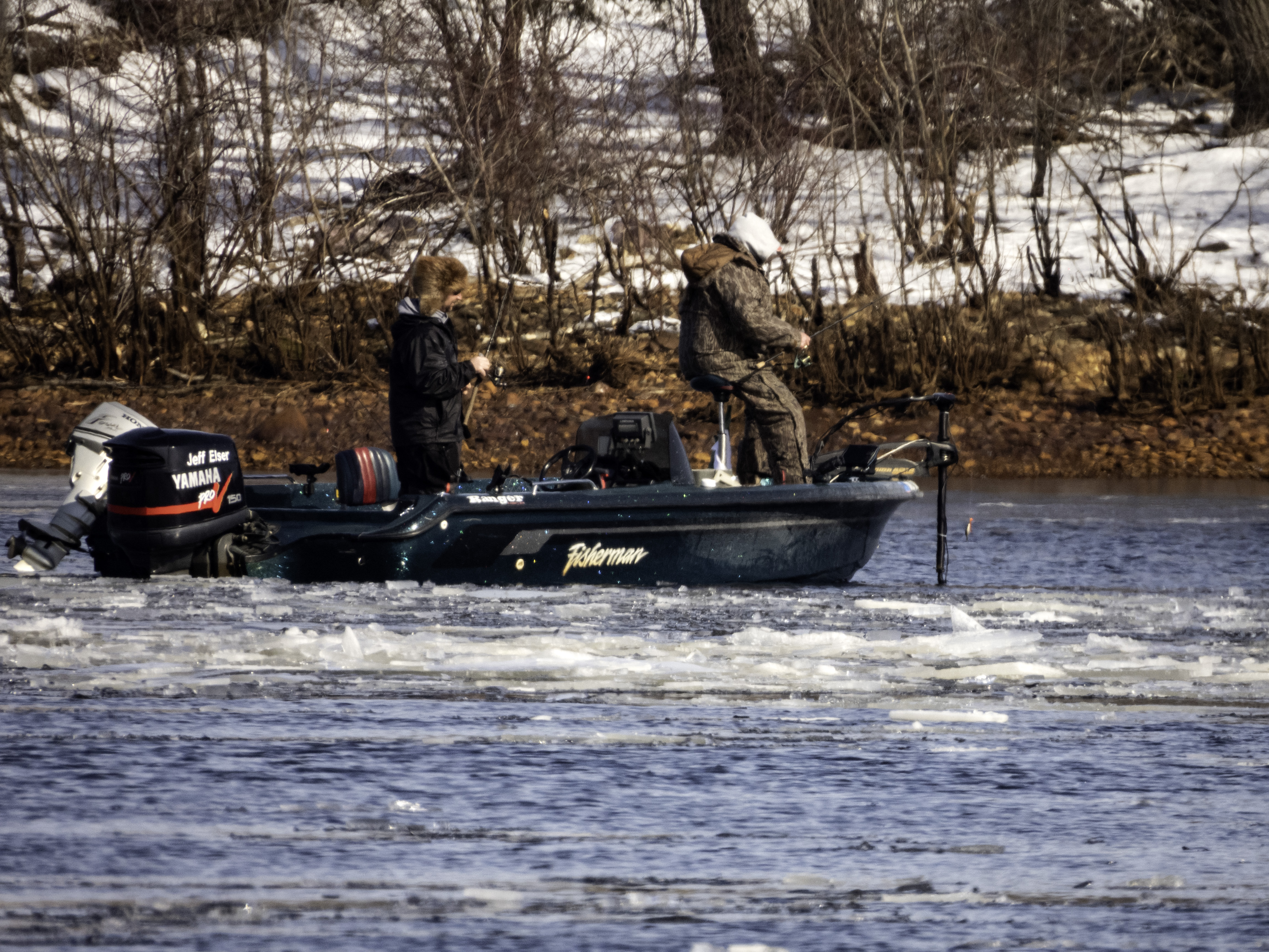 Two people in fishing boat on icy water image - Free stock photo