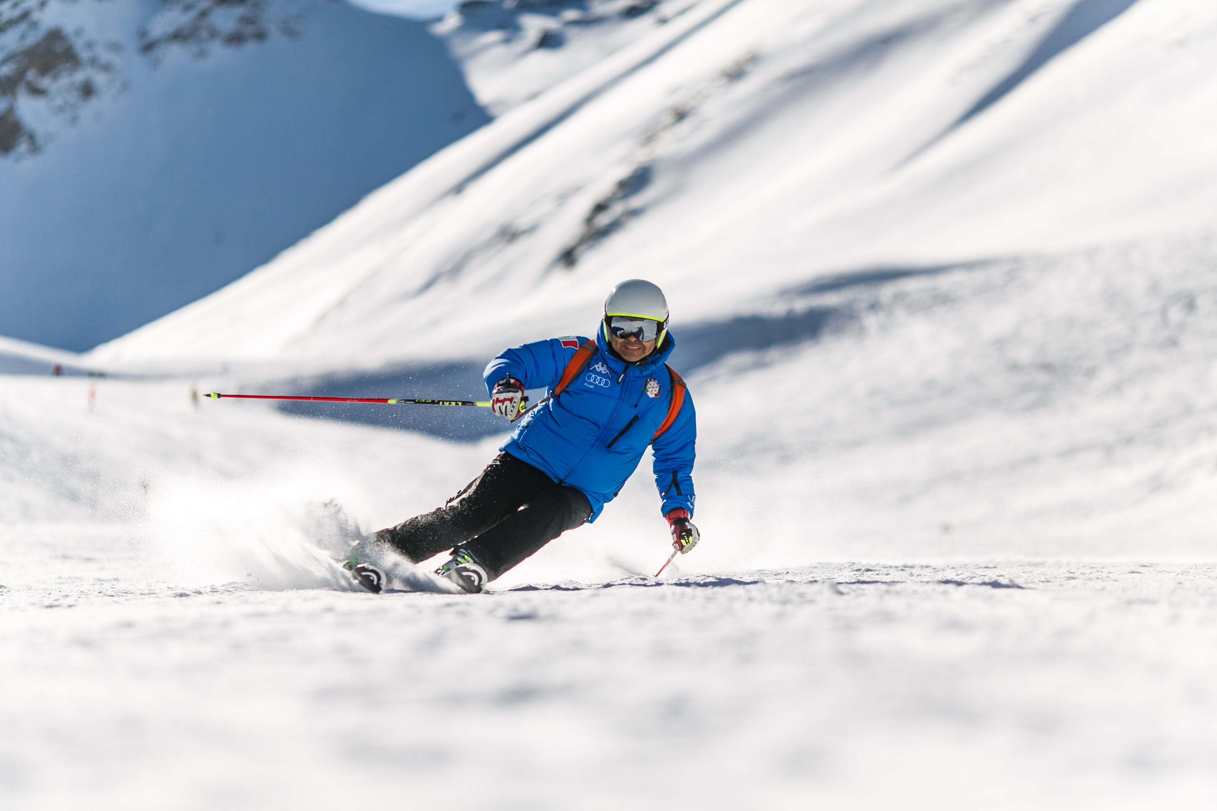 Man Skiing Down A Snowy Mountain 