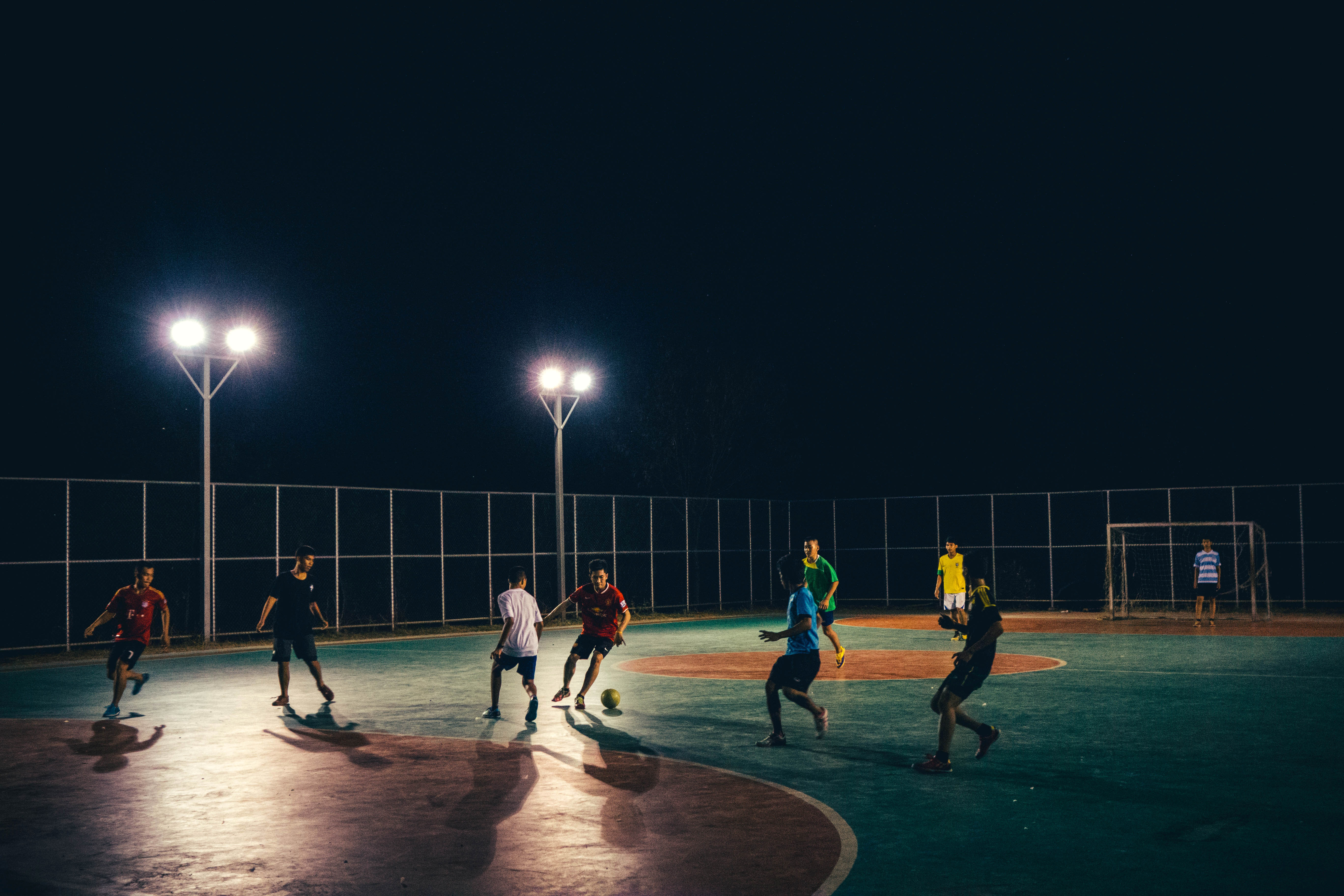 People playing soccer under the streetlamps image - Free stock photo - Public Domain photo - CC0 Images