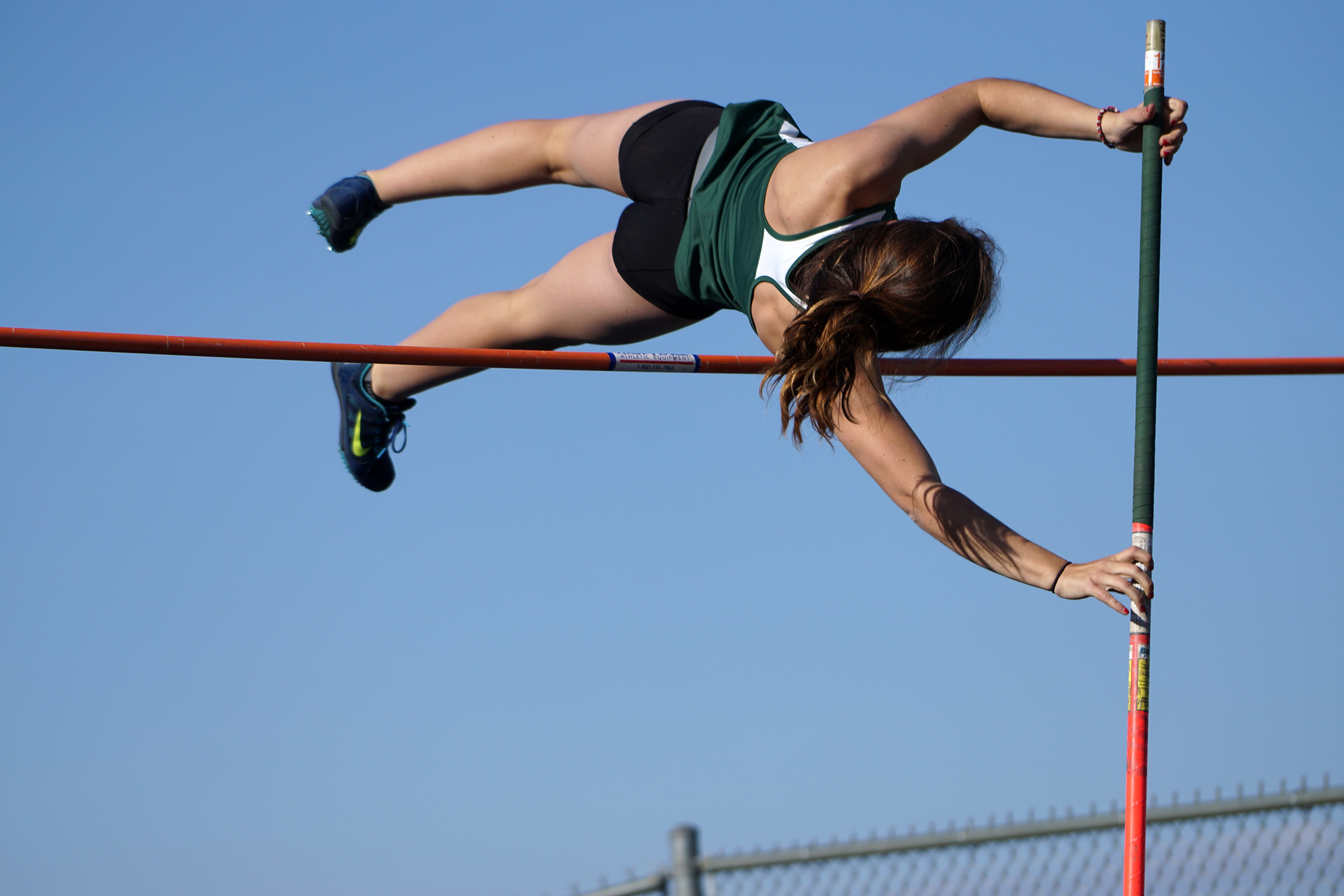 Woman Pole Vaulting over the bar free photo. browse by category. 