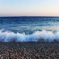 Waves crashing over pebbles on beach