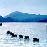 Landscape with hills with small canoes and boats