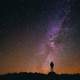 Person standing under the Milky Way