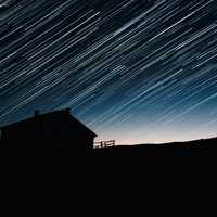 Star Trails and house silhouette at night astrophotography