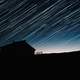 Star Trails and house silhouette at night astrophotography