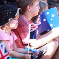 Children wave Australian Flags during Parade in Darwin, Australia