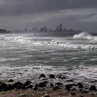 Rough Ocean surf and city skyline in Queensland, Australia