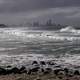 Rough Ocean surf and city skyline in Queensland, Australia