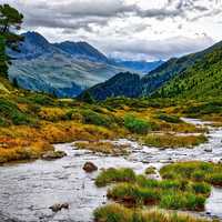 Mountain Valley Landscape with Stream running through 