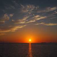 Sunset over the ocean waters under clouds in the Bahamas