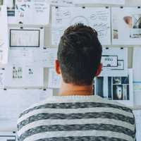 Man Looking at Task Board